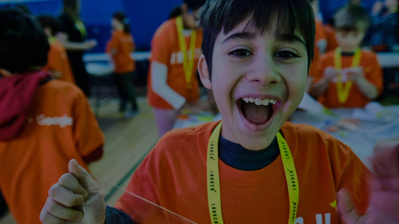 A cheerful young boy beaming with joy as he enjoys LAUNCH Waterloo’s exciting activities!